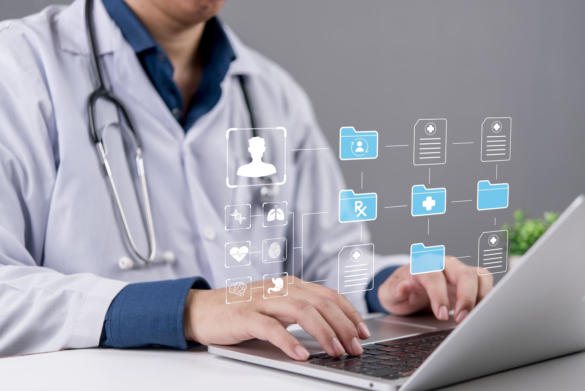 Doctor gestionando historias clínicas digitales en laptop, avance en la transformación digital en salud