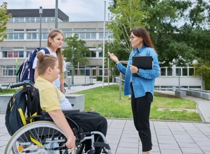 Docente de la especialización en infancia y adolescencia dialogando con estudiantes en un entorno de educación inclusiva dentro del sistema escolar.